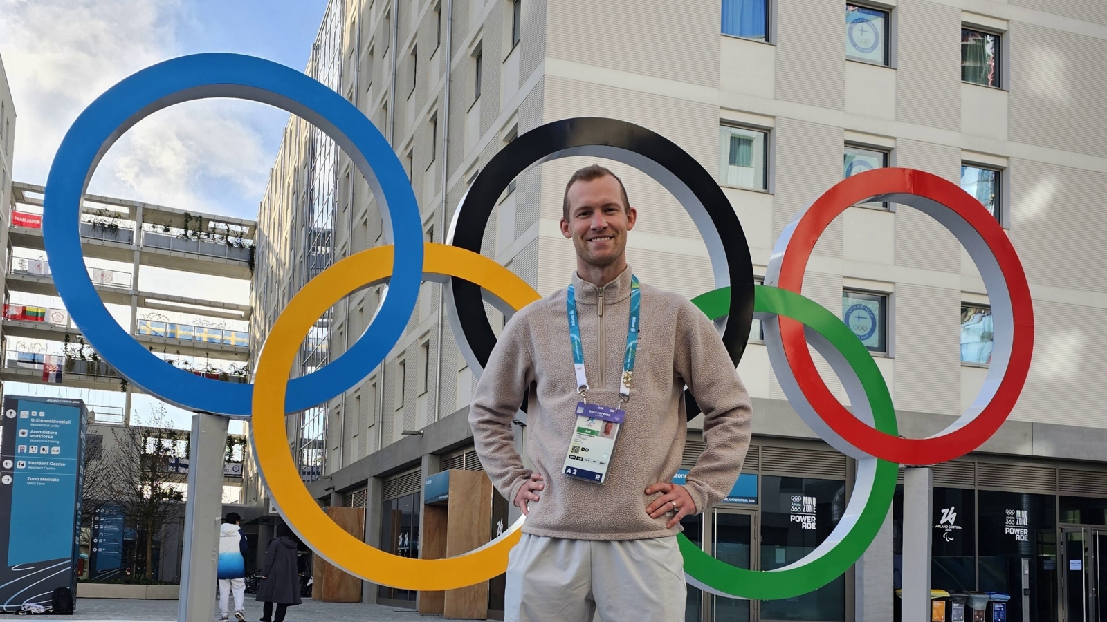 Olympic speed skater Viktor Thorup standing in front of the Olympic rings in Cortina during the Milano-Cortina 2026 Winter Olympics