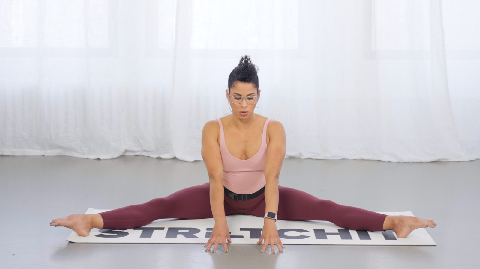 STRETCHIT trainer Alicia Archer practicing a middle split for advanced flexibility STRETCHIT trainer Alicia Archer practicing a middle split for advanced flexibility