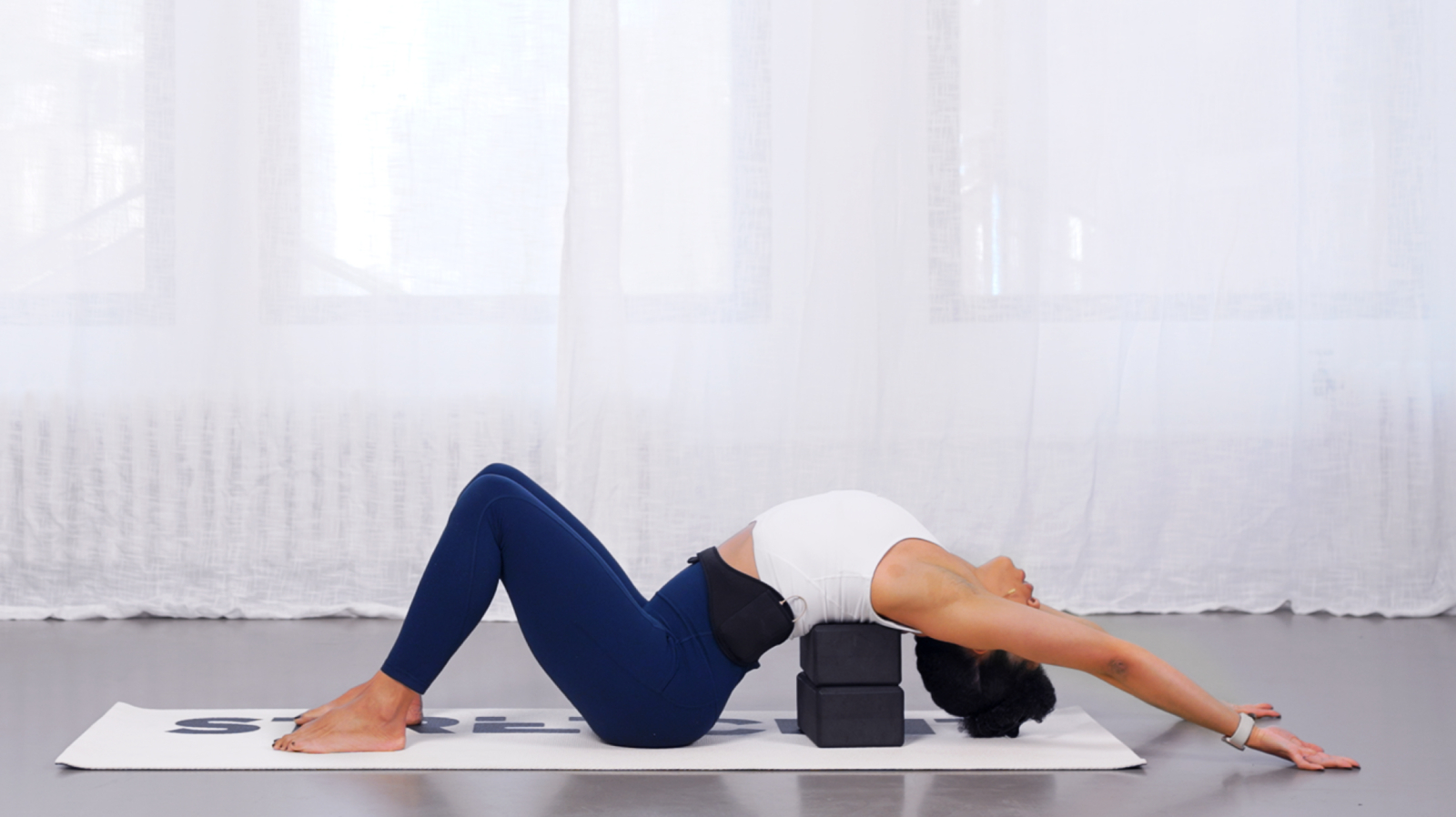 STRETCHIT trainer Alicia Archer in a supported backbend stretch with yoga blocks STRETCHIT trainer Alicia Archer in a supported backbend stretch with yoga blocks